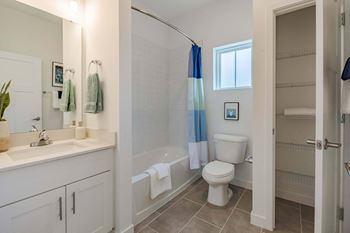 a bathroom with a toilet and a tub and a sink